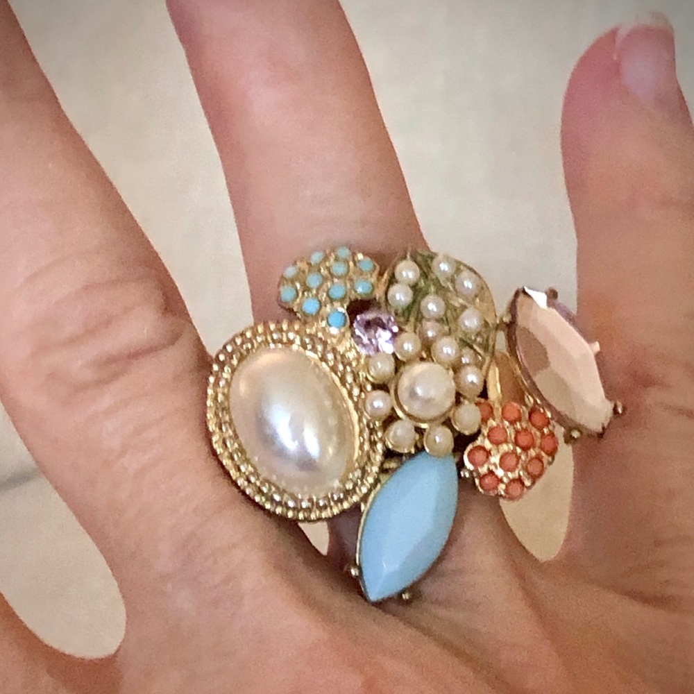 Faux pearl and floral cocktail ring fits any size.